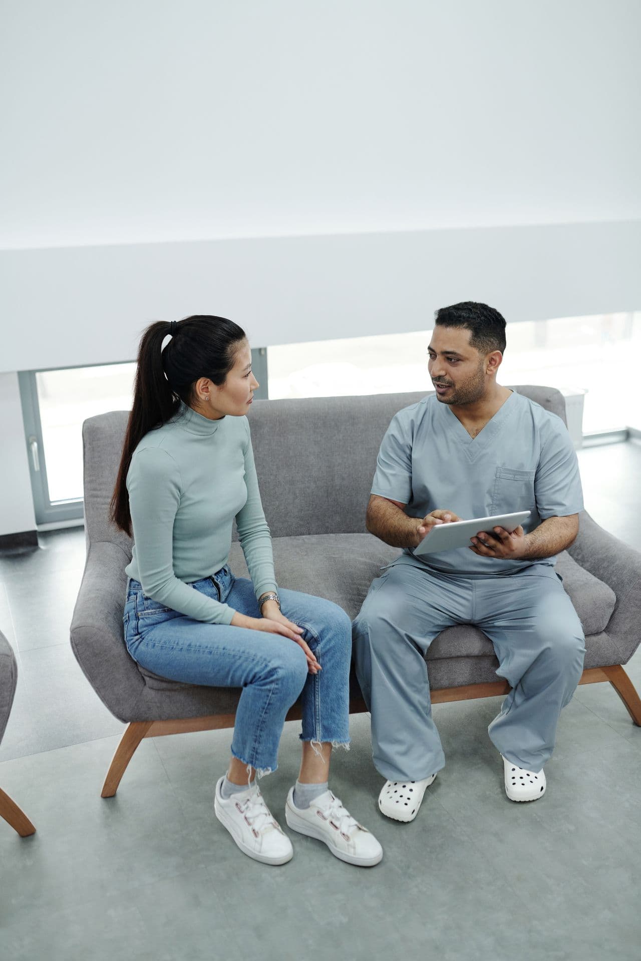 Clinician reviewing intake with a patient in the waiting area